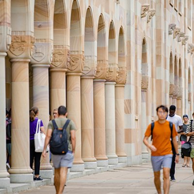 Students walking through the Great Court at UQ St Lucia, which is surrounded by sandstone buildings